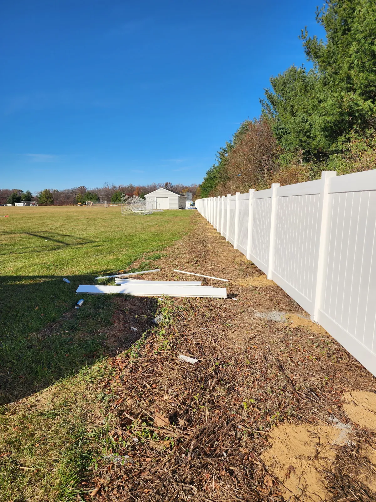 White vinyl privacy fence long installation run