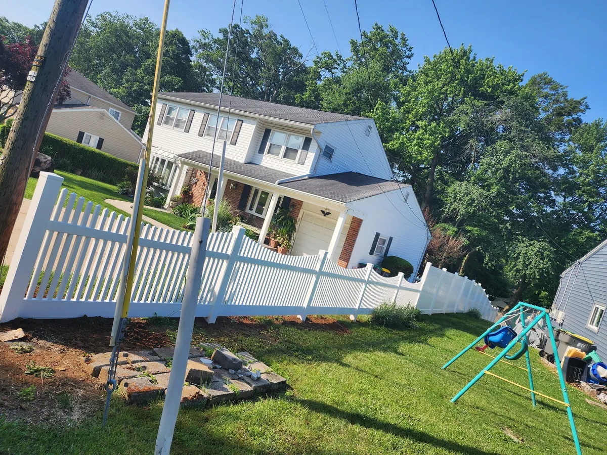 White vinyl picket fence around residential yard