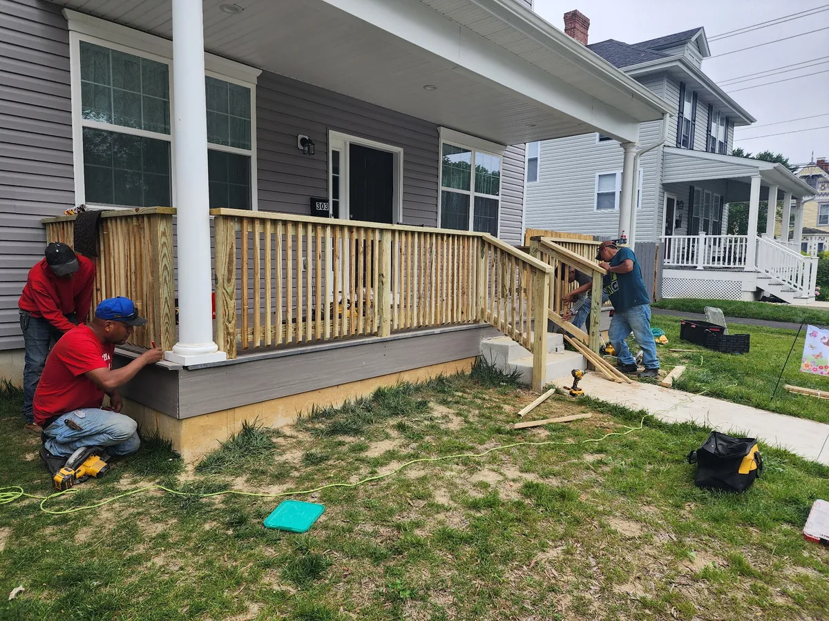 TWOMENS construction crew building custom porch railing